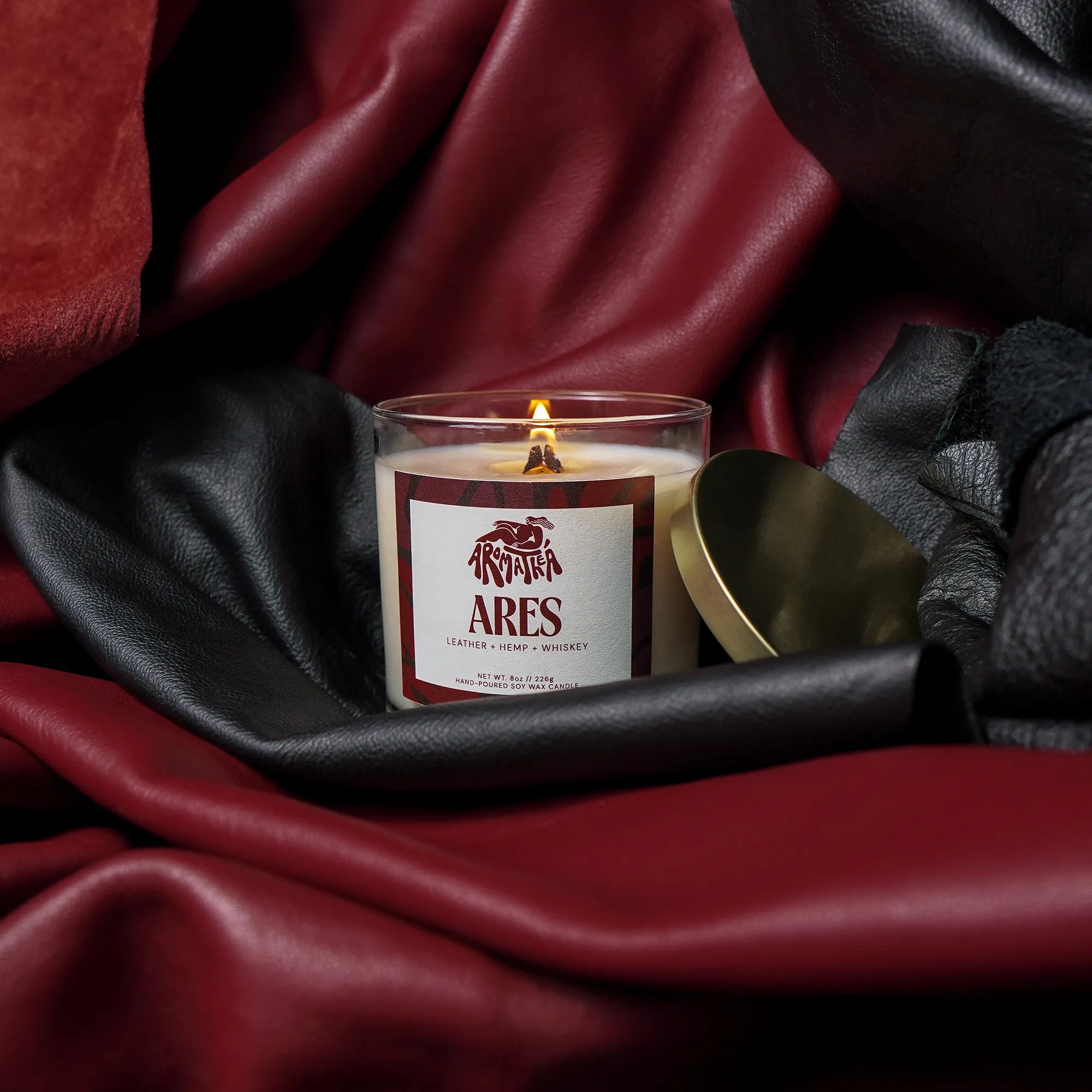 Candle labeled 'Ares' on a dark fabric background