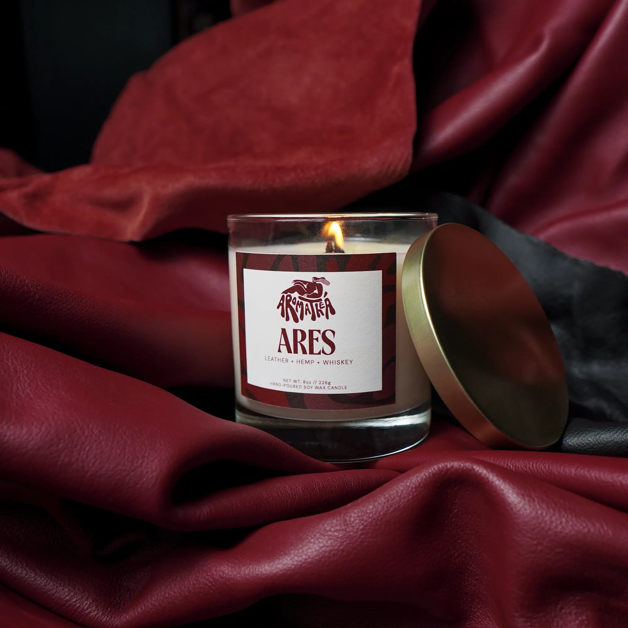Candle labeled 'Ares' on a dark fabric background
